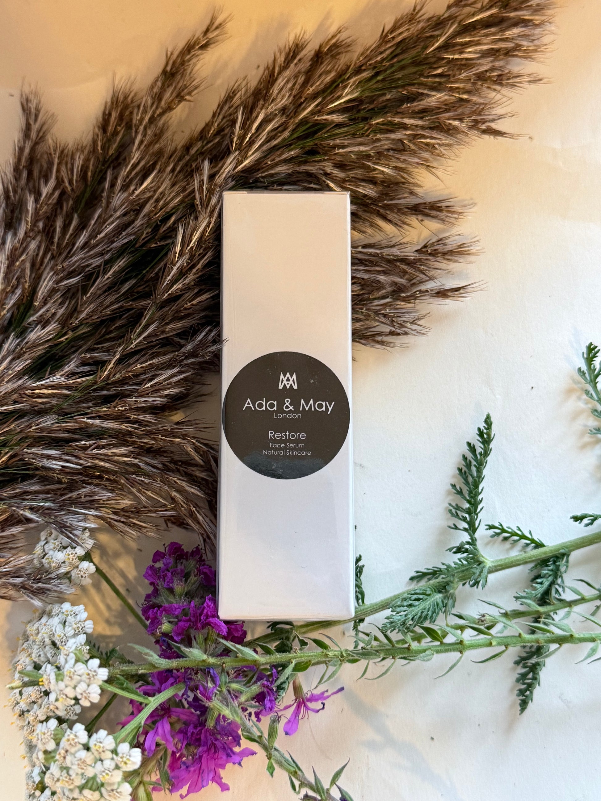 Restore Product box with 'Ava & May' branding on a decorative background with feathers and flowers.